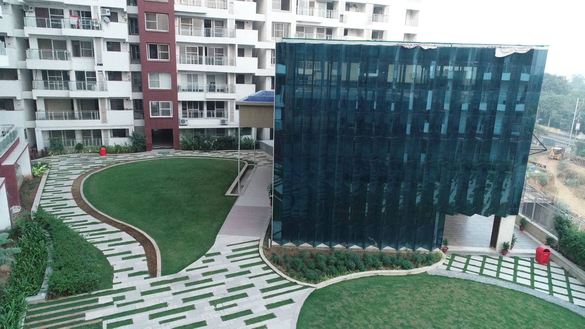 The glass-fronted clubhouse beside the podium lawn