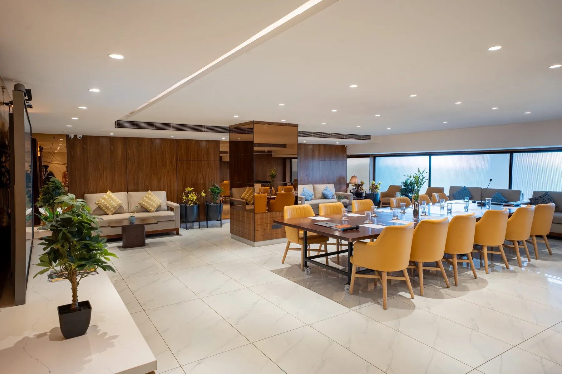 MileStone Conference hall set for a board meeting, with lounge seating beyond the table