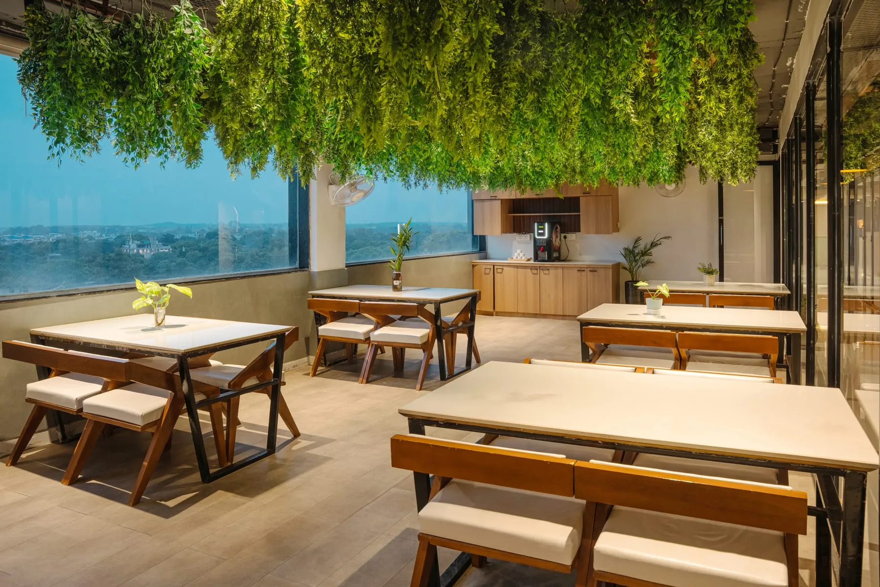 Café window tables with hanging greenery