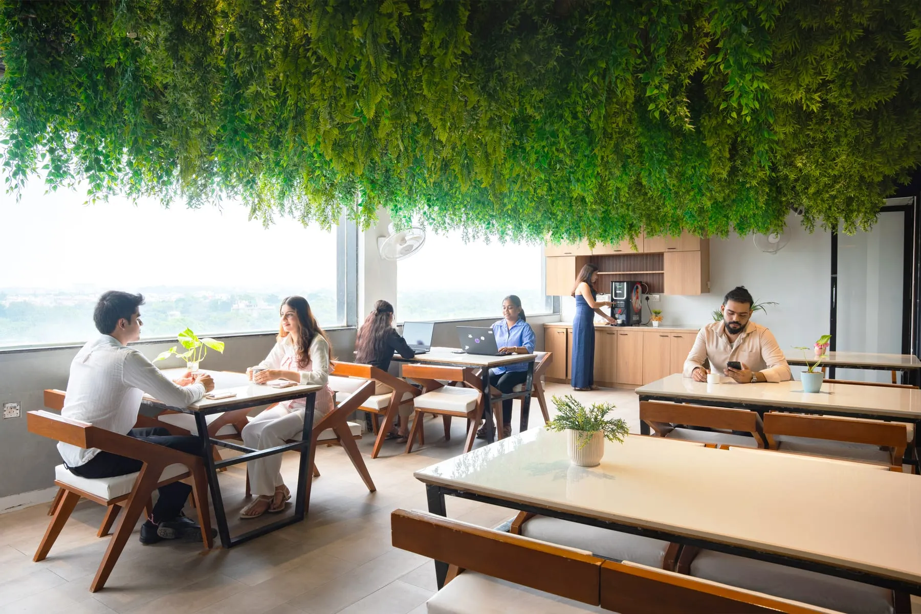People working at the café window at MileStone Coworking