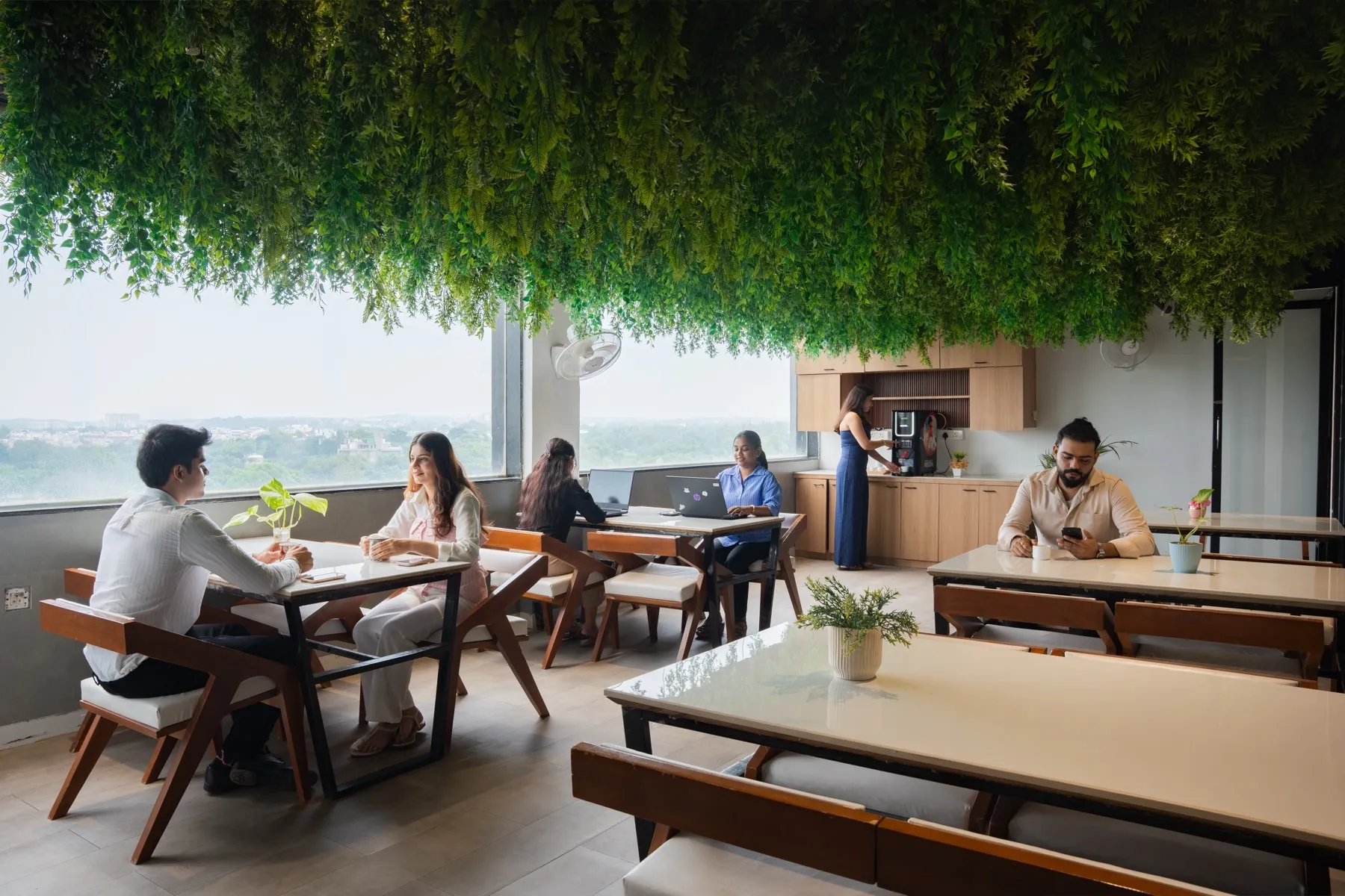 People working at the café window at MileStone Coworking