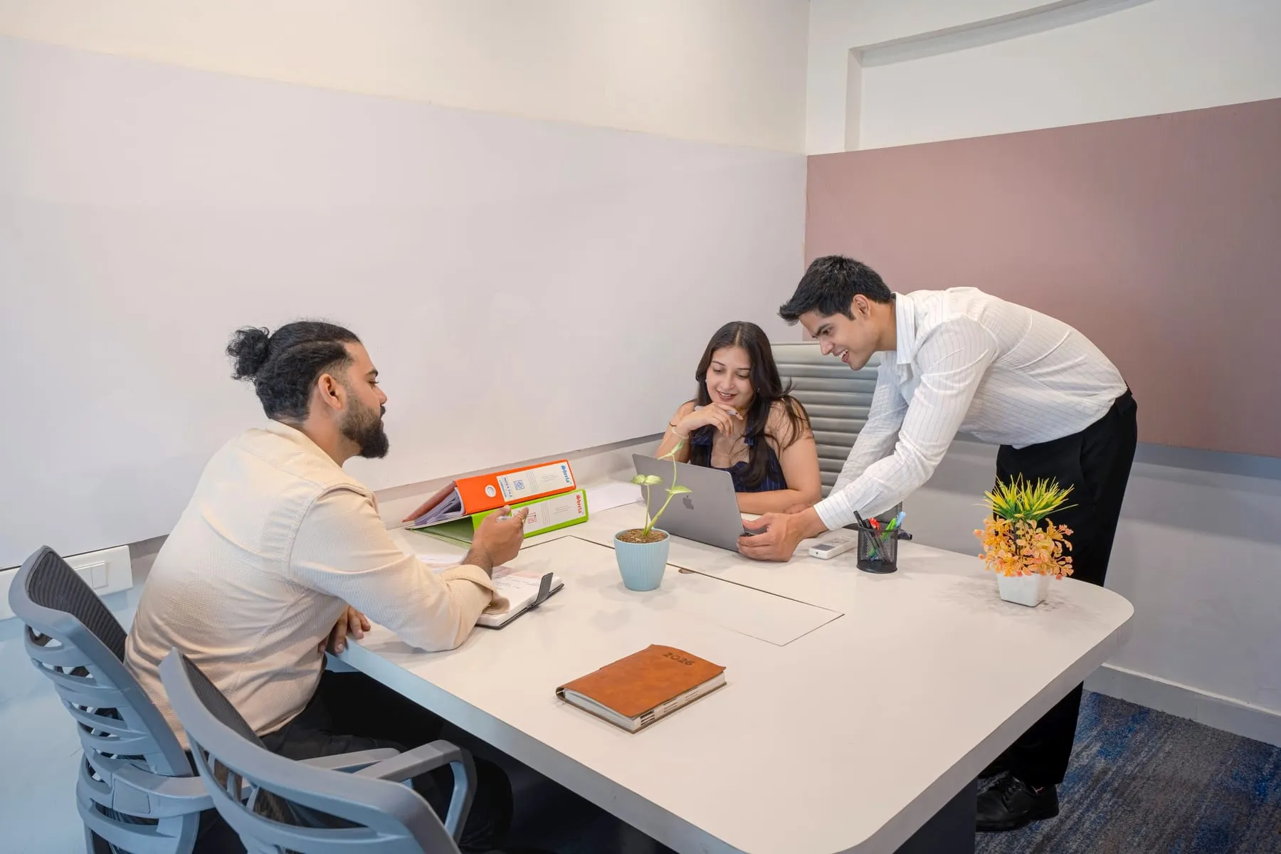 Three people in a director cabin meeting