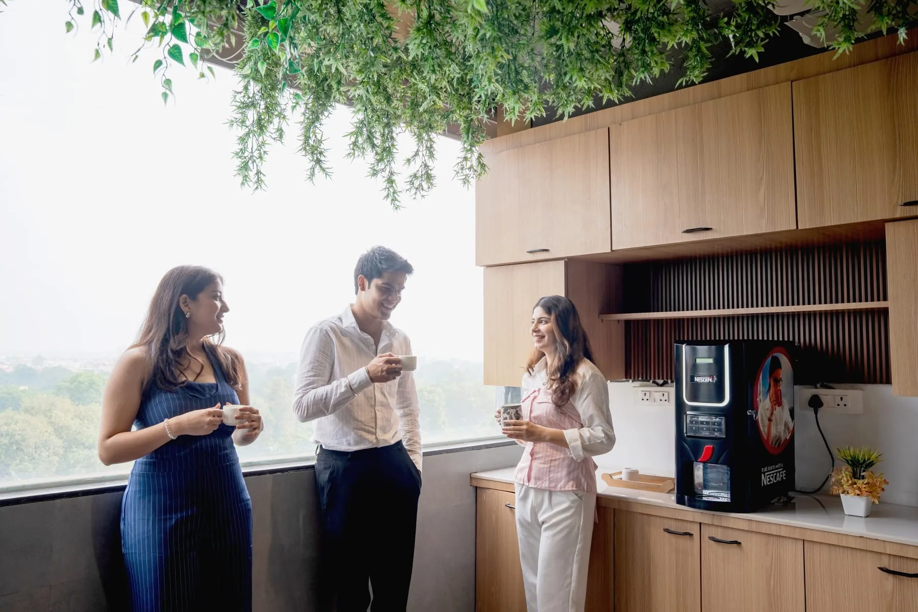 Three people at the pantry coffee counter